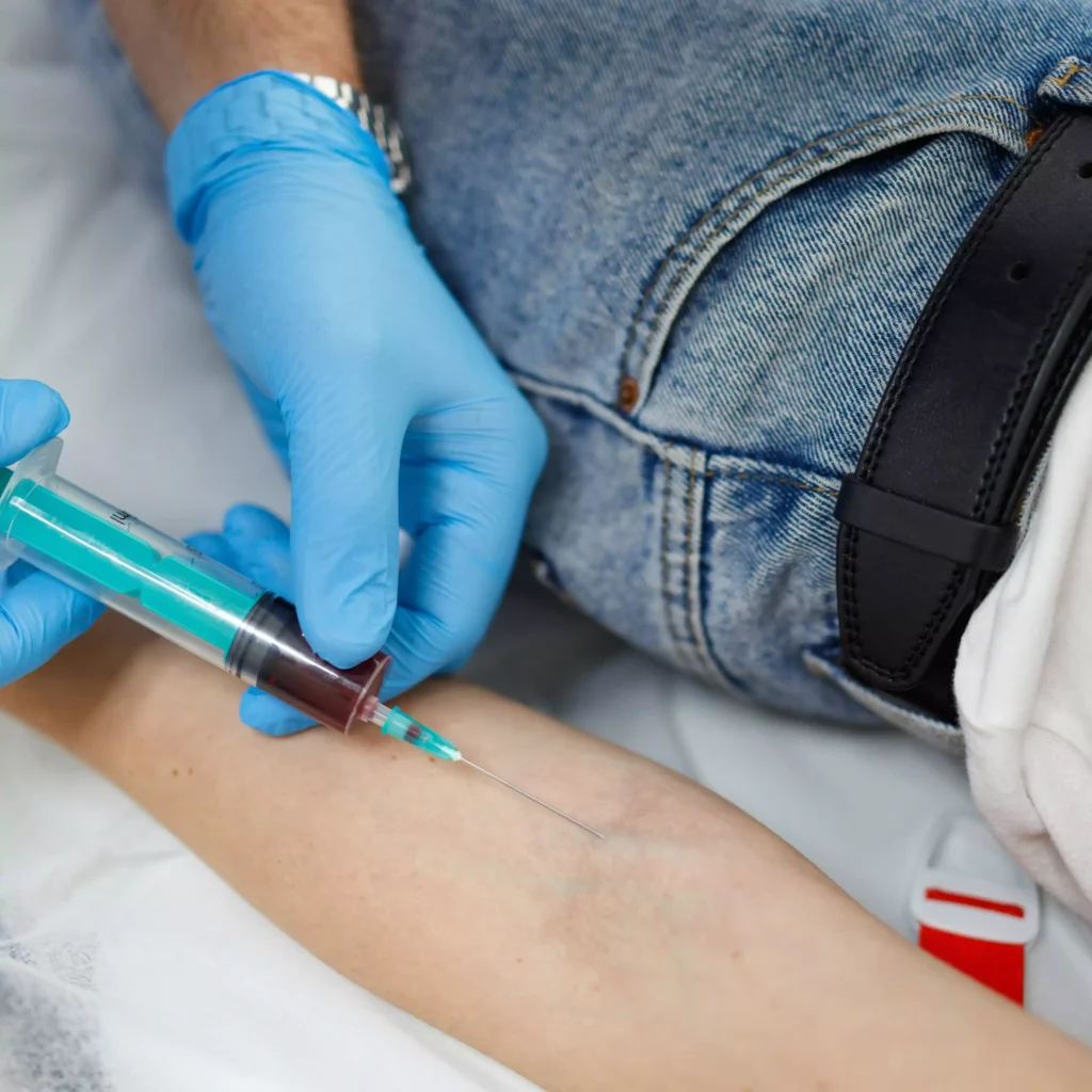 . A person receiving an injection in the arm at home in Ranchi. dressing & injection at home, nursing care services