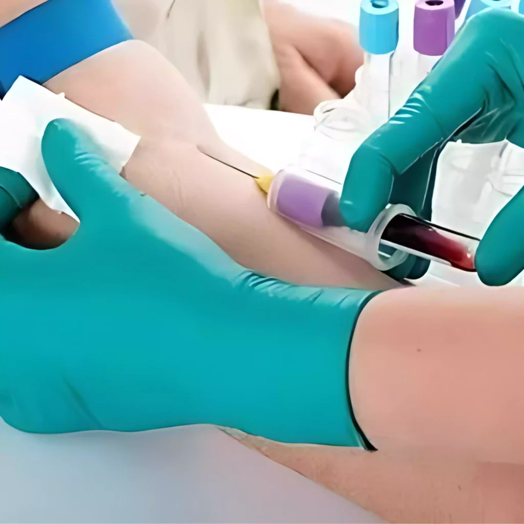 A professional in a green glove collecting blood for a home blood test, part of the blood sample collection services in Ranchi