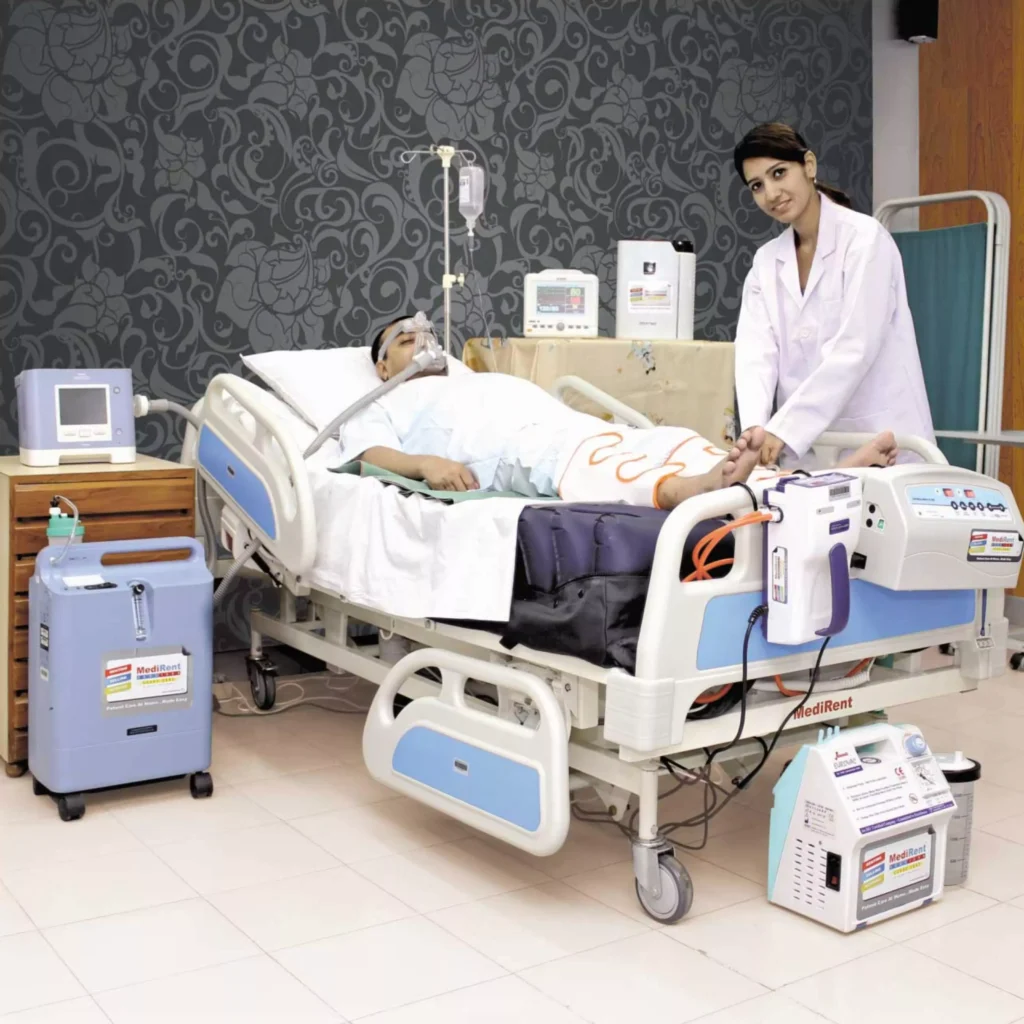 A man lying in a hospital bed, surrounded by medical equipment. Medical equipment rental services available in Ranchi. Top-quality medical equipments on rent