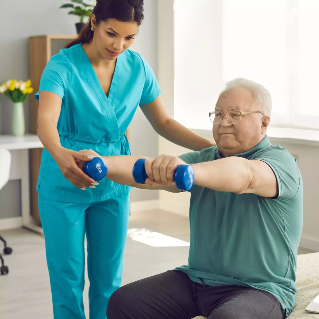 A woman assisting an elderly man with exercise during physiotherapy nursing services at home. physiotherapy at home, nursing care