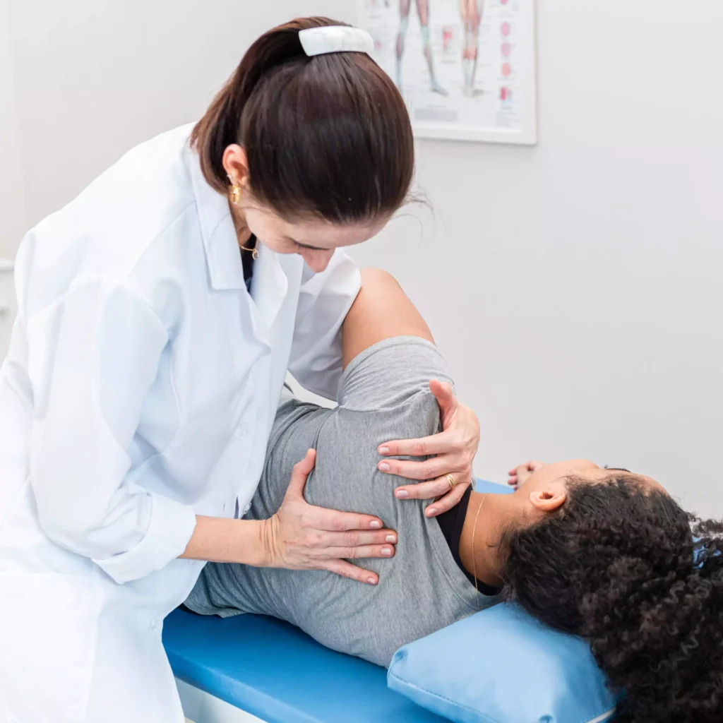 Woman receiving physical therapy adjustment from therapist at home. physiotherapy at home, physiotherapy care services