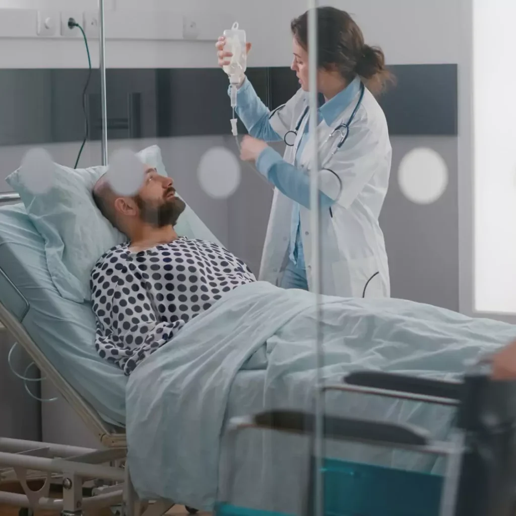 Nurse providing critical care to a man in a patient bed at home in Ranchi. critical care at home, all nursing services at home